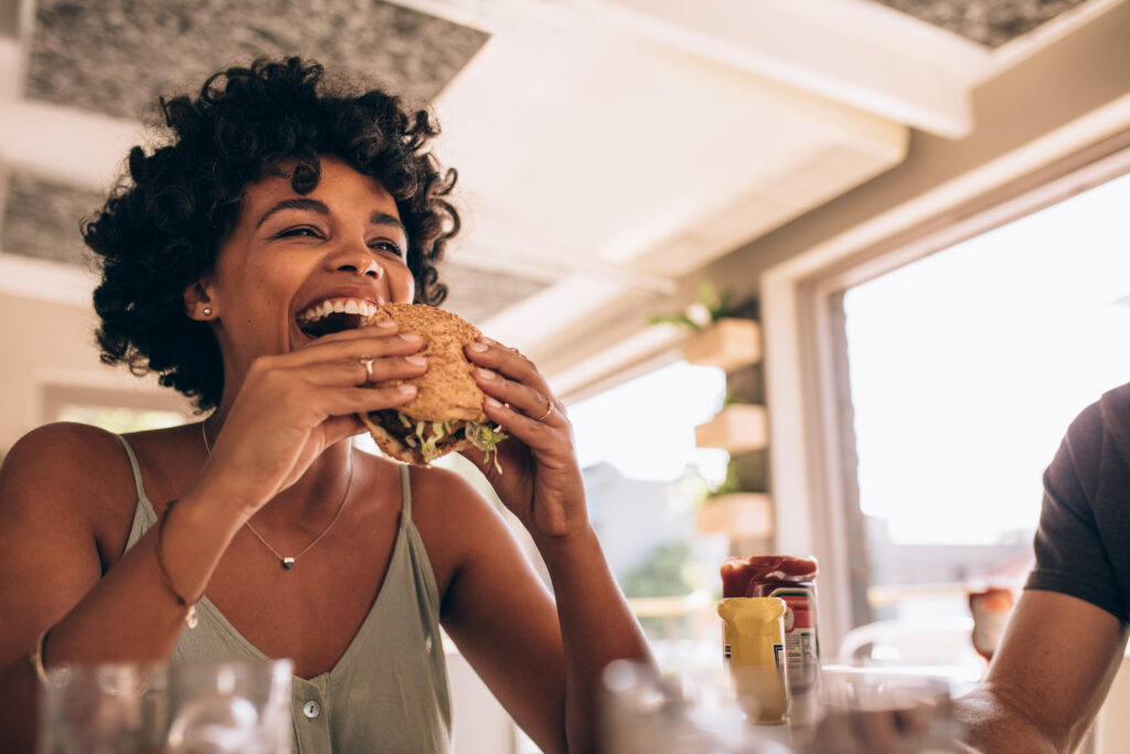 Woman enjoying eating burge